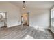 Bright living area with wood-look floors, leading to the bathroom at 818 E Charles St, Matthews, NC 28105