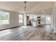 Open-concept living space with wood-look floors, connecting to the kitchen at 818 E Charles St, Matthews, NC 28105