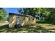 View of the back of the house with small windows and an exterior door at 819 Circle Vw, Gastonia, NC 28054