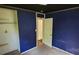 Bedroom with dark blue walls and trim, as well as a closet and wood door at 819 Circle Vw, Gastonia, NC 28054