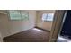 A bedroom with carpeted flooring and two windows allowing for natural light at 819 Circle Vw, Gastonia, NC 28054