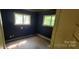 Bedroom featuring dark painted walls, windows, and baseboard heaters at 819 Circle Vw, Gastonia, NC 28054