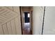Hallway with wood paneled walls and hardwood flooring leading to a bedroom at 819 Circle Vw, Gastonia, NC 28054