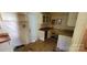 This kitchen includes a side entrance, upper and lower cabinets, and laminate countertops at 819 Circle Vw, Gastonia, NC 28054