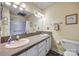 Bathroom featuring double sinks with granite countertops and white cabinets, along with a shower and toilet at 84 Lake Concord Ne Rd # S, Concord, NC 28025