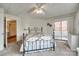 Cozy bedroom featuring a queen bed, soft carpet, ceiling fan, and access to an outdoor balcony at 84 Lake Concord Ne Rd # S, Concord, NC 28025