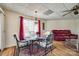 Inviting dining room with a glass table set, red curtains, and wood-look flooring at 84 Lake Concord Ne Rd # S, Concord, NC 28025