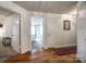 Hallway featuring hardwood floors with views into multiple rooms including a bright bedroom at 84 Lake Concord Ne Rd # S, Concord, NC 28025