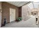 Well-lit hallway with brick walls, carpet flooring, and a skylight, leading to the unit's entrance at 84 Lake Concord Ne Rd # S, Concord, NC 28025