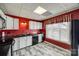 Modern kitchen features white cabinets, black appliances, and a red tiled backsplash at 84 Lake Concord Ne Rd # S, Concord, NC 28025