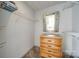 Bright walk-in closet featuring carpeted floors, shelving, and a built-in wood dresser with a mirror at 84 Lake Concord Ne Rd # S, Concord, NC 28025