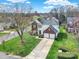 An aerial view of a two-story house with a large front yard and a long driveway leading to a two-car garage at 8620 Grey Squirrel Ct, Charlotte, NC 28277