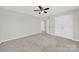 Spacious bedroom with neutral carpet, ceiling fan, and closet doors for storage space at 8620 Grey Squirrel Ct, Charlotte, NC 28277