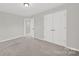 Bedroom with neutral paint, carpet, ceiling fan, and closet for storage at 8620 Grey Squirrel Ct, Charlotte, NC 28277