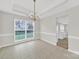 Dining room features tile flooring, modern lighting, and a view of the backyard at 8620 Grey Squirrel Ct, Charlotte, NC 28277