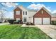 Inviting two-story home featuring a brick facade, white siding, and a well-manicured lawn at 8620 Grey Squirrel Ct, Charlotte, NC 28277