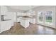 Eat-in kitchen with white cabinetry and a functional island, filled with natural light at 8620 Grey Squirrel Ct, Charlotte, NC 28277