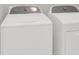 A side-by-side white laundry washing machine and dryer appliance set in laundry room at 8620 Grey Squirrel Ct, Charlotte, NC 28277