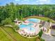 Aerial view showcasing the community pool, waterslide, and clubhouse with well-manicured landscaping at 8633 Sequoia Grove Ln, Charlotte, NC 28214