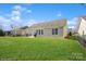 Wide shot of backyard with concrete patio, grilling area, and privacy fencing at 8633 Sequoia Grove Ln, Charlotte, NC 28214