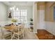 Charming dining room featuring a round table, elegant chandelier, and wainscoting, perfect for Gathering meals at 8633 Sequoia Grove Ln, Charlotte, NC 28214