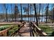 Wooden dock leads to a tranquil lake setting, perfect for enjoying waterfront living and scenic views at 8633 Sequoia Grove Ln, Charlotte, NC 28214