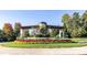 Stone entrance with manicured landscaping, colorful flowers and community signage offering a welcoming arrival at 8633 Sequoia Grove Ln, Charlotte, NC 28214