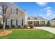 Charming home featuring a well-manicured lawn, shuttered windows, and stone accents on the facade at 8633 Sequoia Grove Ln, Charlotte, NC 28214