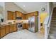 Well-lit kitchen with stainless steel appliances and wooden cabinets, offering both style and functionality at 8633 Sequoia Grove Ln, Charlotte, NC 28214