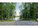 Paved access path down to a serene lake with a dock, providing convenient waterfront access for residents at 8633 Sequoia Grove Ln, Charlotte, NC 28214