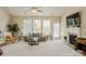 Bright living room with a fireplace, large windows, and neutral tones, offering a serene and inviting atmosphere at 8633 Sequoia Grove Ln, Charlotte, NC 28214