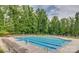 Enjoy this refreshing neighborhood swimming pool with plenty of seating surrounded by beautiful trees at 8633 Sequoia Grove Ln, Charlotte, NC 28214