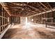 Interior of a large barn featuring a dirt floor, an exposed rafter ceiling, and ample space for storage and projects at 9026 Nc 10 Hwy, Vale, NC 28168