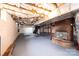 Unfinished basement with painted floor, brick fireplace, and utility access at 9026 Nc 10 Hwy, Vale, NC 28168