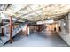 Unfinished basement with painted floor, stairs, and exposed ceiling insulation at 9026 Nc 10 Hwy, Vale, NC 28168