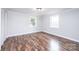 Bright bedroom featuring wood-look flooring, two windows, crown molding and a closet at 9026 Nc 10 Hwy, Vale, NC 28168