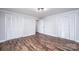 Bright bedroom featuring wood-look flooring, crown molding and two closets at 9026 Nc 10 Hwy, Vale, NC 28168