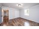 Bedroom features hardwood floors, white walls and trim, a window, and a closet at 9026 Nc 10 Hwy, Vale, NC 28168