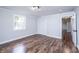 Bright bedroom featuring wood-look flooring, a window, crown molding and a closet at 9026 Nc 10 Hwy, Vale, NC 28168