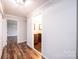 Hallway leading to bathroom features hardwood floors and white walls and trim at 9026 Nc 10 Hwy, Vale, NC 28168