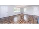 Bright living room featuring hardwood floors and fresh paint, great natural light at 9026 Nc 10 Hwy, Vale, NC 28168