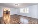 Well-lit living room with hardwood floors and view to kitchen at 9026 Nc 10 Hwy, Vale, NC 28168