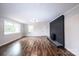 Spacious living room featuring hardwood floors and a modern painted brick fireplace at 9026 Nc 10 Hwy, Vale, NC 28168