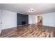 Comfortable living room with brick fireplace and hardwood flooring at 9026 Nc 10 Hwy, Vale, NC 28168