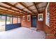 Enclosed brick patio with painted floor, access door, and overhead covering for outdoor enjoyment and entertainment at 9026 Nc 10 Hwy, Vale, NC 28168