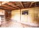 Rustic shed interior with exposed wood beams, corrugated metal walls, and built-in wooden storage shelves at 9026 Nc 10 Hwy, Vale, NC 28168