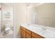 Bathroom features double sinks with wood cabinets, tile floors, and a toilet at 9433 Gilpatrick Ln, Huntersville, NC 28078