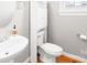 Cozy half bathroom featuring a pedestal sink, over the toilet storage, and a window for natural light at 9433 Gilpatrick Ln, Huntersville, NC 28078