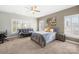 Neutral bedroom featuring shuttered windows, soft carpet, ceiling fan, and a cozy daybed at 9433 Gilpatrick Ln, Huntersville, NC 28078