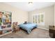 Bright bedroom with light blue walls, carpet, a window, and bookshelves at 9433 Gilpatrick Ln, Huntersville, NC 28078